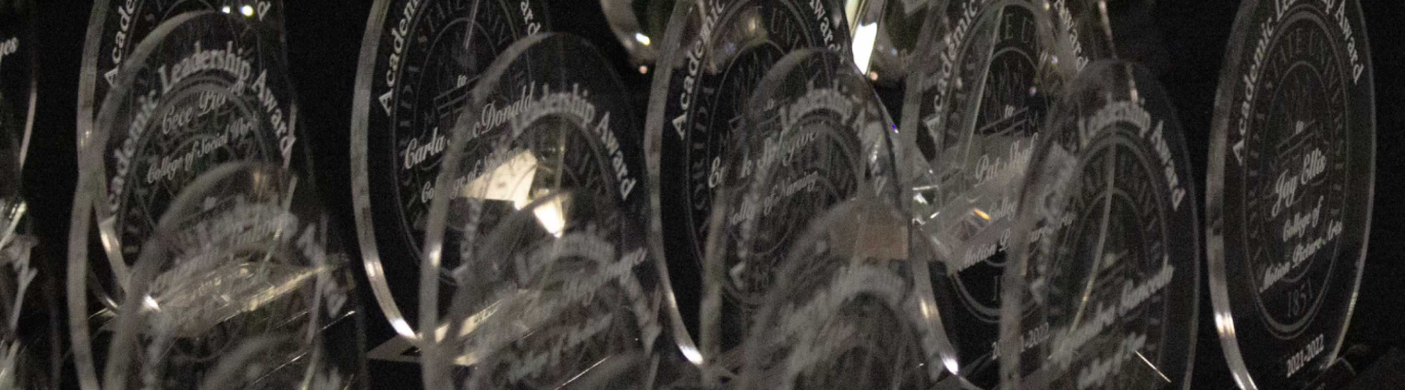 Round, glass awards with white writing